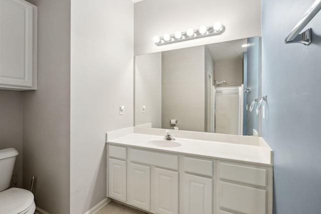 bathroom with vanity, toilet, and a shower with door