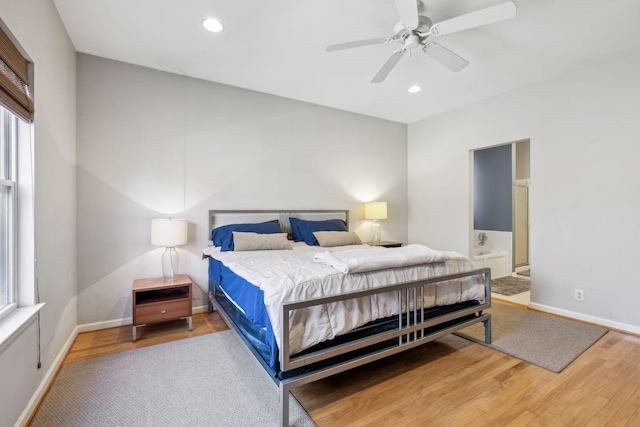 bedroom with ensuite bath, wood-type flooring, and ceiling fan