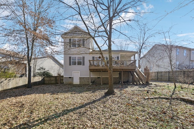 rear view of property featuring a wooden deck