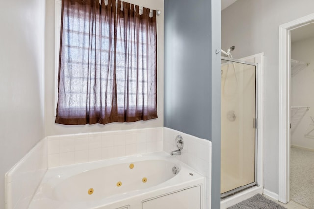 bathroom featuring shower with separate bathtub