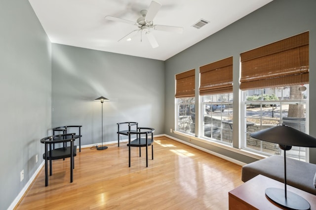 living area with ceiling fan and light wood-type flooring