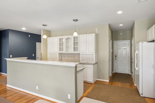 kitchen featuring white fridge, white cabinets, and light hardwood / wood-style floors