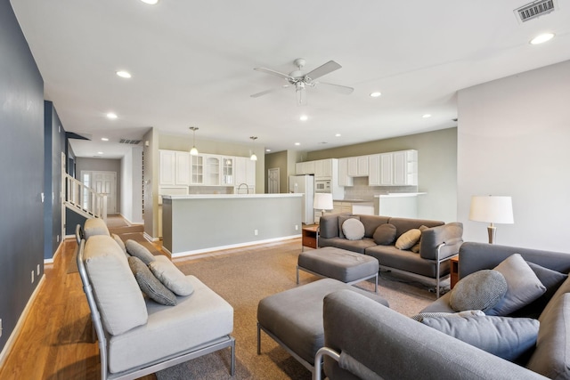 living room with sink and ceiling fan