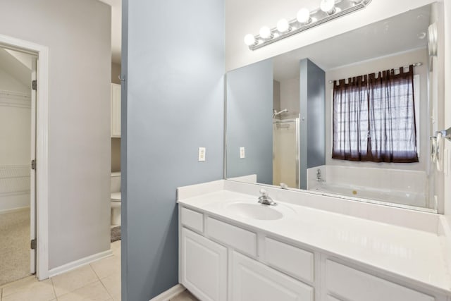 bathroom with vanity, a washtub, tile patterned floors, and toilet