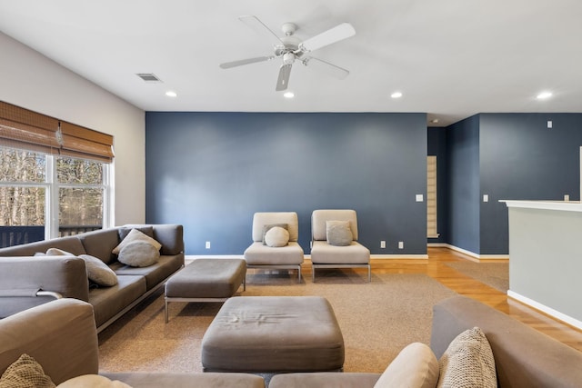 living room with light hardwood / wood-style flooring and ceiling fan