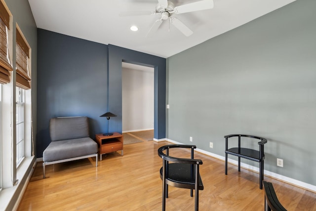 sitting room with ceiling fan and light hardwood / wood-style floors