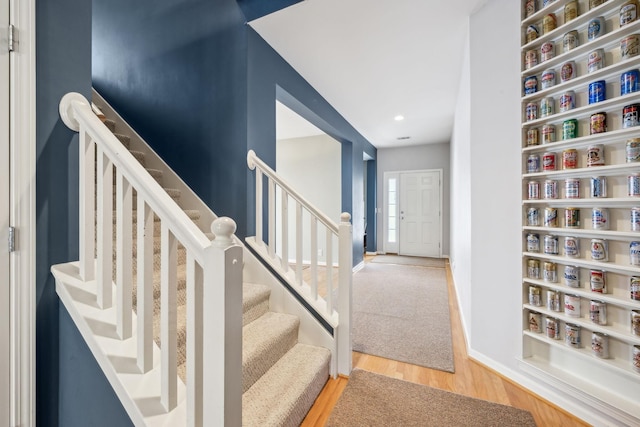 staircase with wood-type flooring