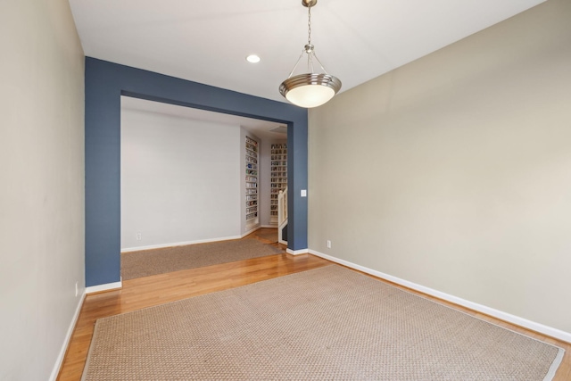 empty room with hardwood / wood-style flooring