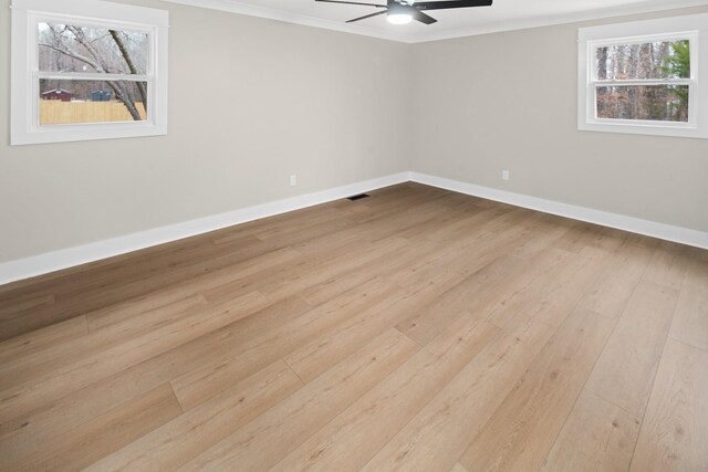 empty room with ceiling fan, ornamental molding, and light hardwood / wood-style flooring