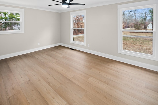 spare room featuring light hardwood / wood-style flooring, ornamental molding, and ceiling fan