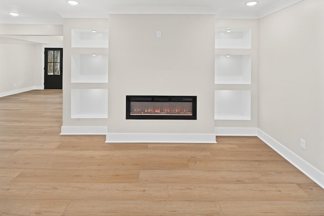 unfurnished living room with crown molding, light wood-type flooring, and built in shelves