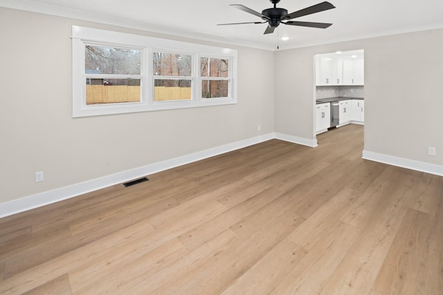 unfurnished room with ornamental molding, ceiling fan, and light wood-type flooring