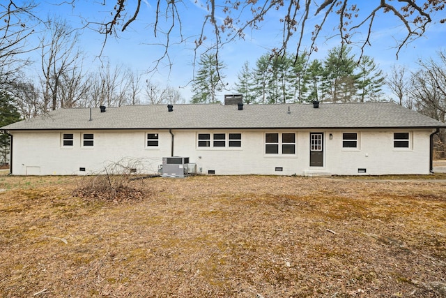 rear view of property with a yard and central AC unit