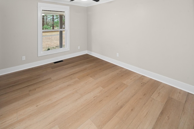 empty room featuring ceiling fan and light hardwood / wood-style flooring