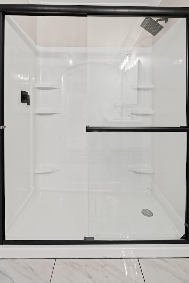 bathroom featuring a shower with shower door