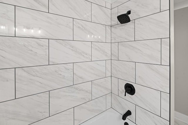 interior details with tiled shower / bath