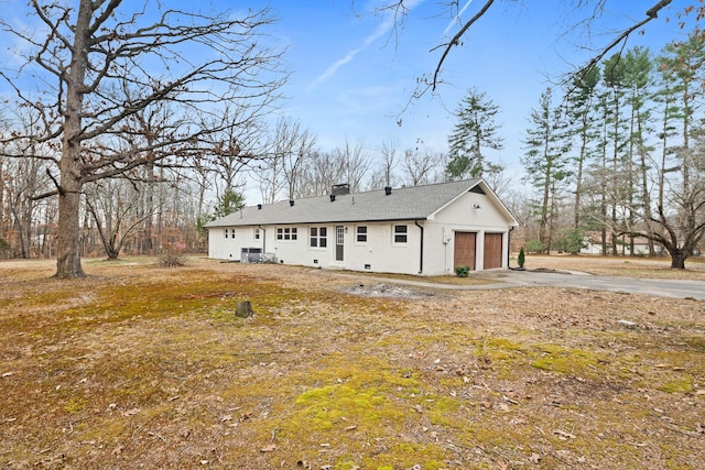 back of house featuring a garage