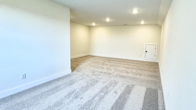 spare room featuring light colored carpet