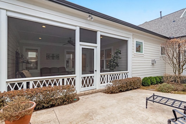 view of exterior entry featuring a patio and ceiling fan