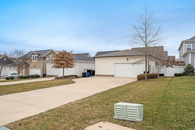 view of home's exterior with a garage and a lawn