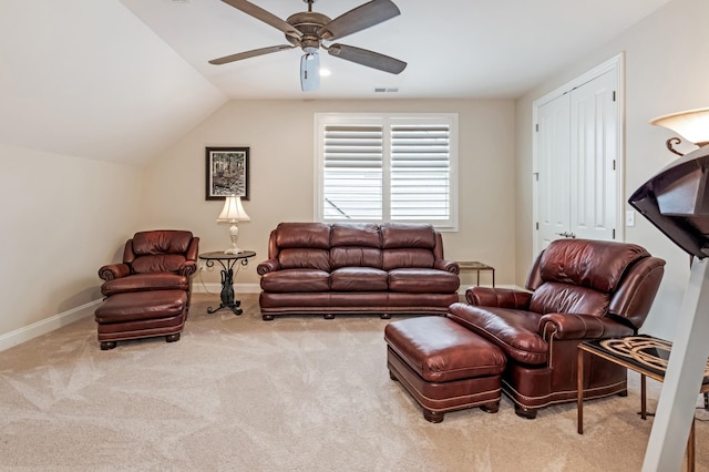 carpeted living room featuring vaulted ceiling and ceiling fan