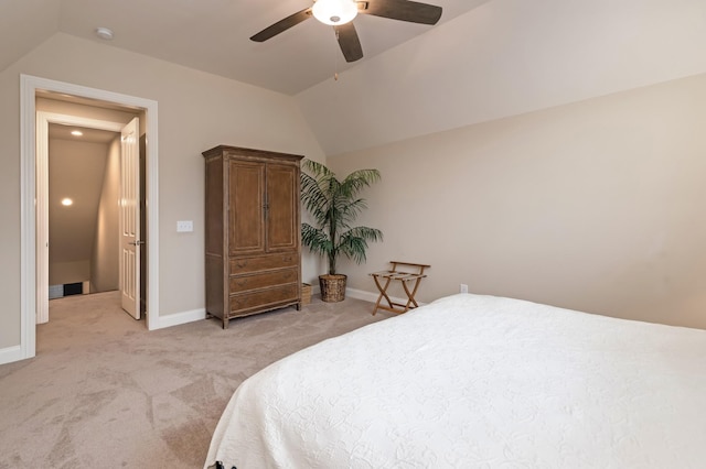 bedroom featuring lofted ceiling, light colored carpet, and ceiling fan