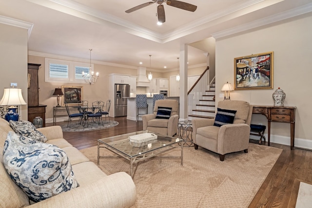 living room featuring crown molding, dark hardwood / wood-style floors, and ceiling fan with notable chandelier