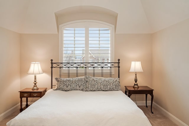 carpeted bedroom with vaulted ceiling