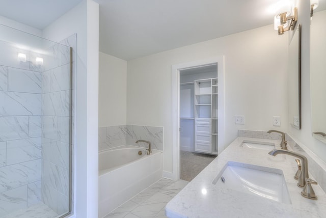 bathroom featuring vanity and shower with separate bathtub