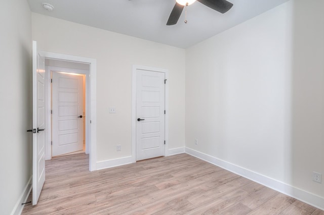 unfurnished bedroom with ceiling fan and light hardwood / wood-style flooring