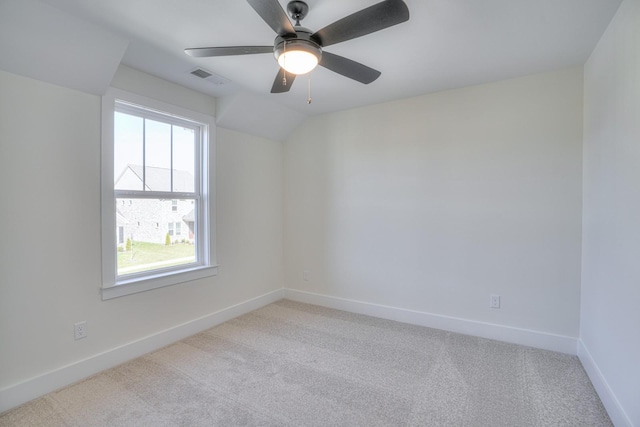 carpeted empty room featuring ceiling fan and vaulted ceiling