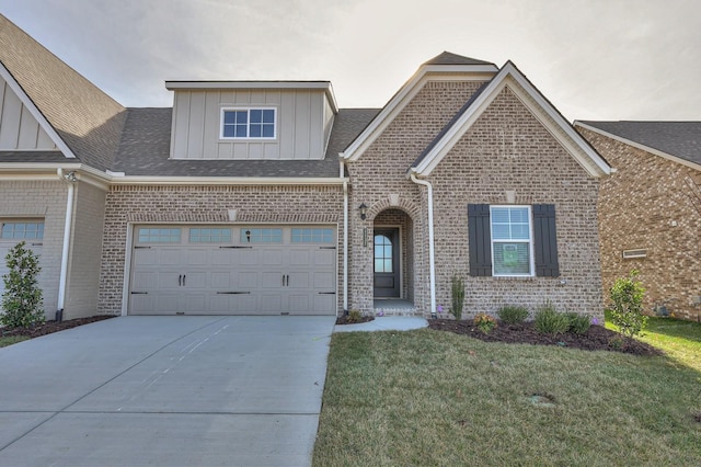 view of front of property featuring a garage and a front lawn