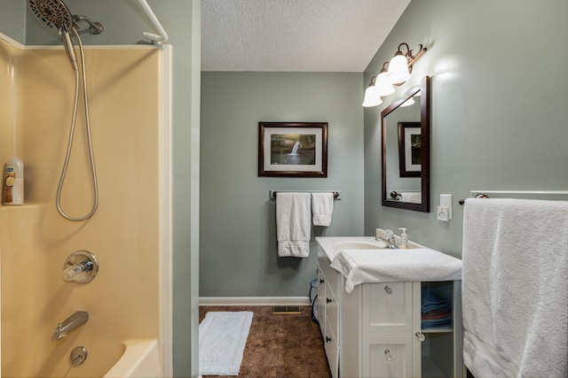 bathroom with  shower combination, a textured ceiling, and vanity