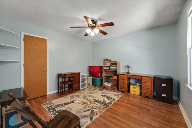 office featuring ceiling fan, hardwood / wood-style floors, and a textured ceiling