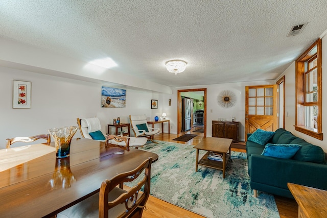 living room with hardwood / wood-style flooring and a textured ceiling