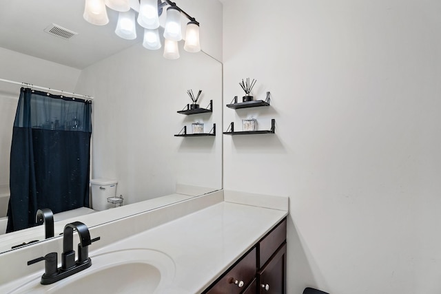 bathroom featuring vanity, toilet, and a shower with shower curtain