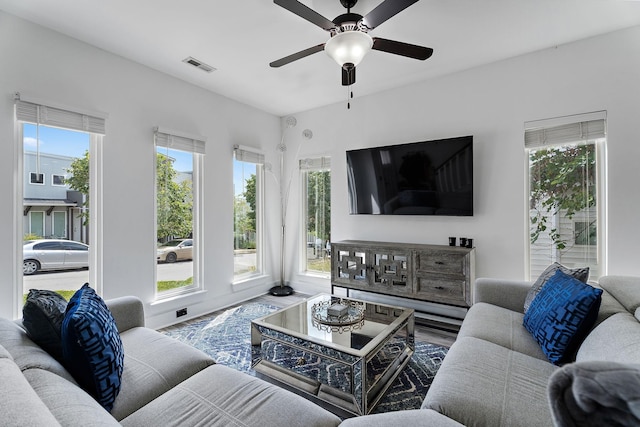 living room with wood-type flooring and ceiling fan