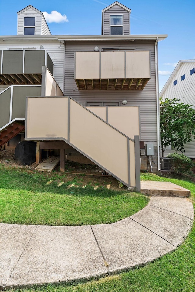 view of home's exterior featuring a yard and central air condition unit