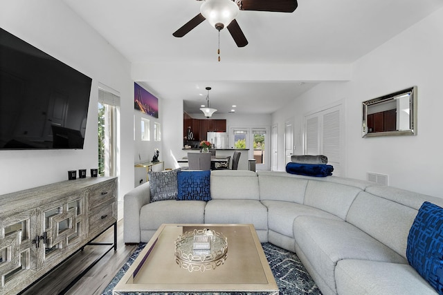 living room featuring hardwood / wood-style floors and ceiling fan