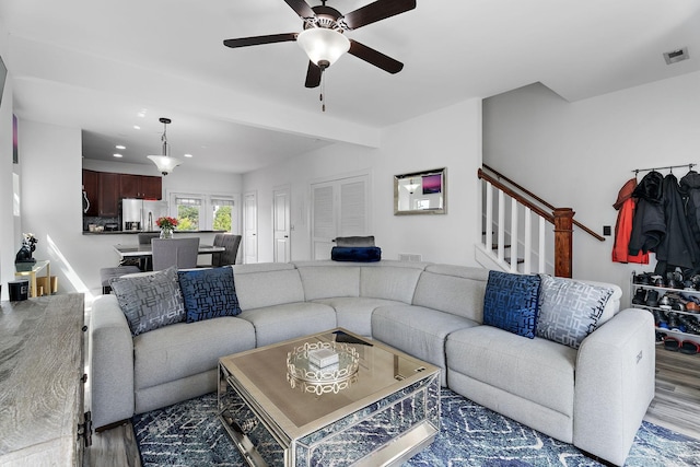 living room featuring hardwood / wood-style flooring and ceiling fan