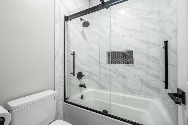 full bath with shower / bath combination with glass door and toilet