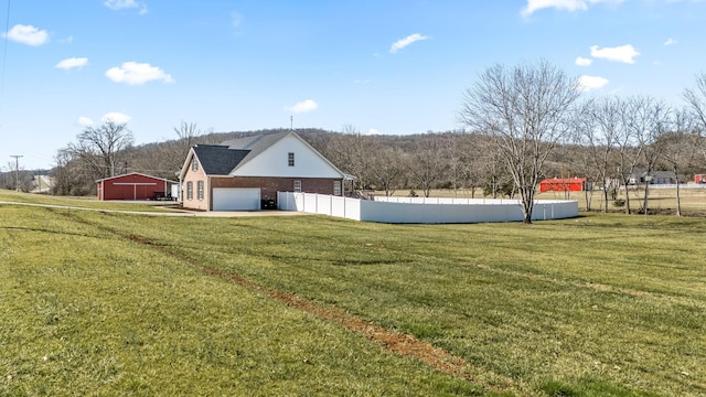 view of yard with a garage and fence