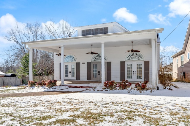 view of front of house featuring ceiling fan, fence, and french doors