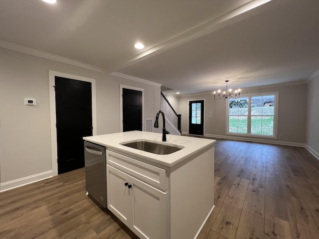 kitchen with an island with sink, sink, white cabinets, ornamental molding, and stainless steel dishwasher