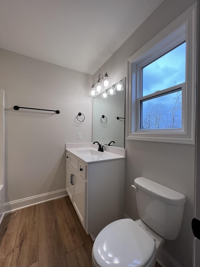 bathroom featuring hardwood / wood-style flooring, vanity, and toilet