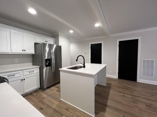 kitchen featuring stainless steel refrigerator with ice dispenser, sink, dark hardwood / wood-style floors, a kitchen island with sink, and white cabinets