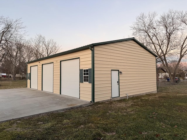 garage at dusk with a yard