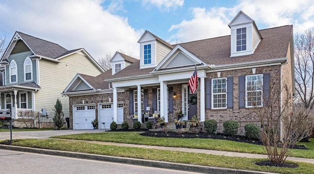 cape cod home featuring a garage, covered porch, and a front lawn