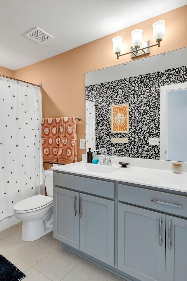 bathroom featuring vanity, tile patterned floors, and toilet