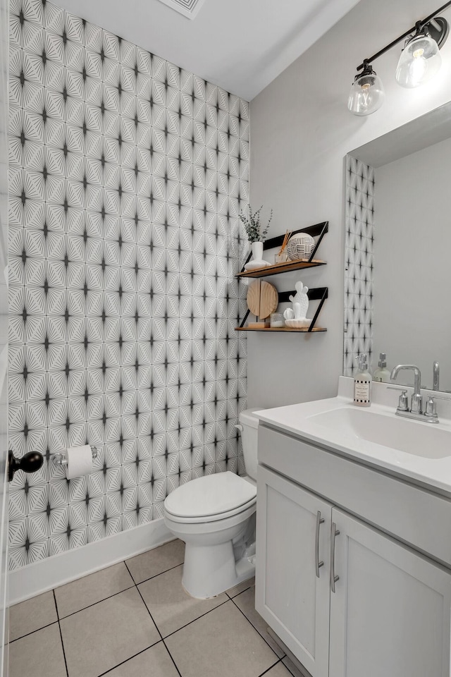 bathroom with vanity, tile patterned floors, and toilet